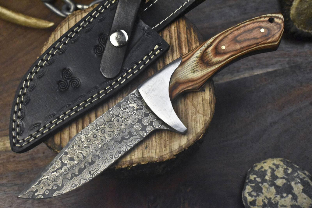 Custom handmade J2 steel hunting knife with a 10-inch pakkawood handle, steel bolster, and leather sheath.