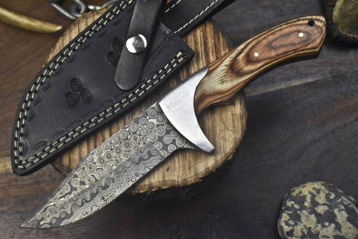 Custom handmade J2 steel hunting knife with a 10-inch pakkawood handle, steel bolster, and leather sheath.