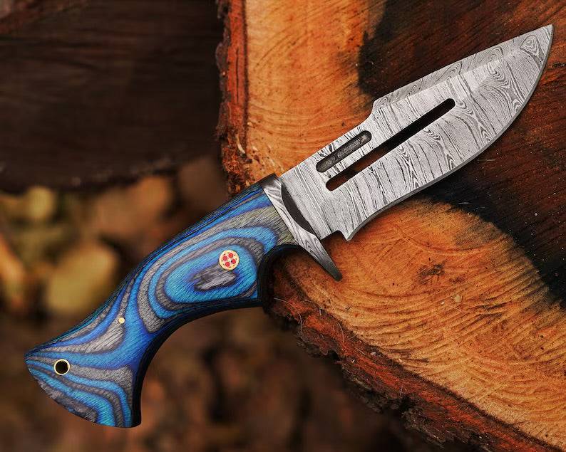 Damascus steel hunting knife by cskforged with a textured handle and sharp blade, ideal for outdoor hunting and survival tasks.