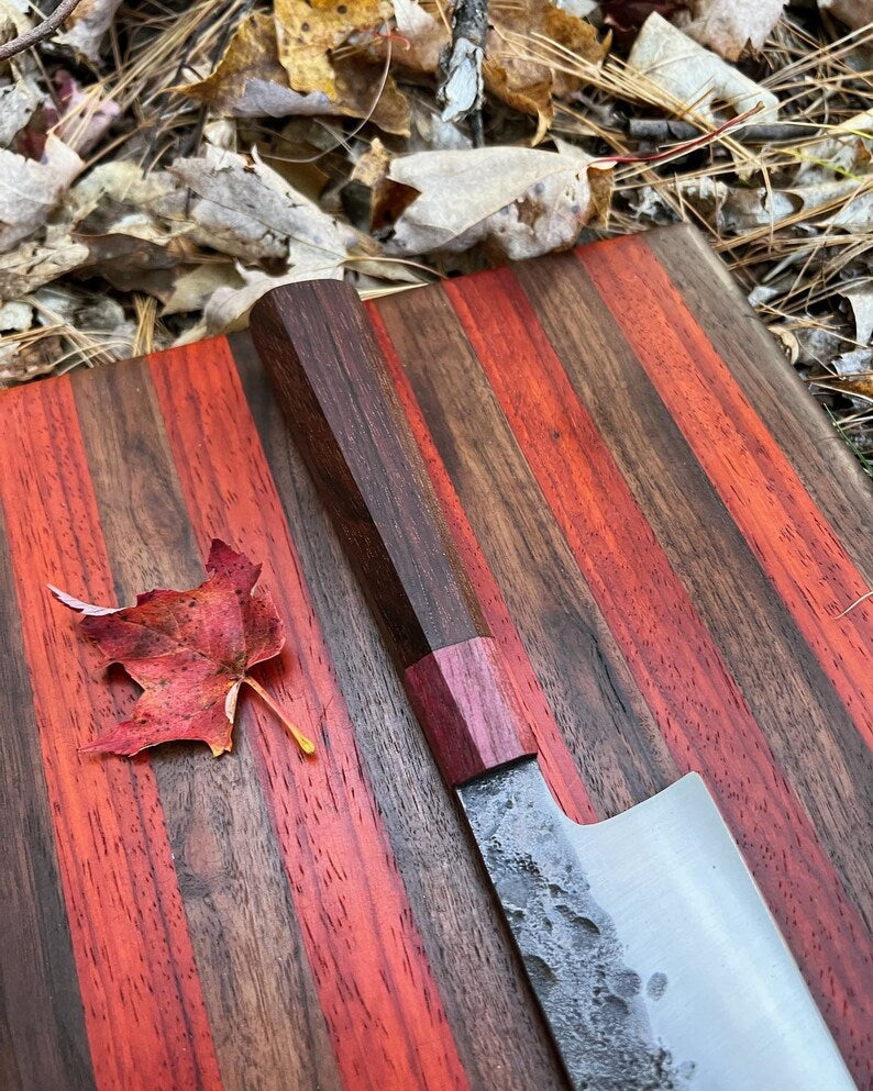 Lightweight chef knife by Knives Gear Garage with a sharp stainless steel blade and ergonomic handle, ideal for precise kitchen prep.