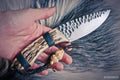 Handmade skinning hunting knife from Knives Gear Garage with a sleek blade and wooden handle, ideal for outdoor hunting activities.