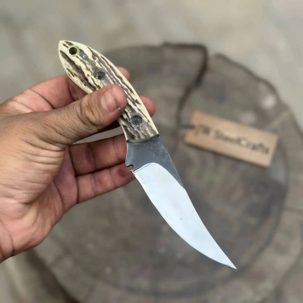 JW SteelCrafts high carbon upswept skinning knife with fixed blade and synthetic stag horn handle, ideal for hunting tasks.