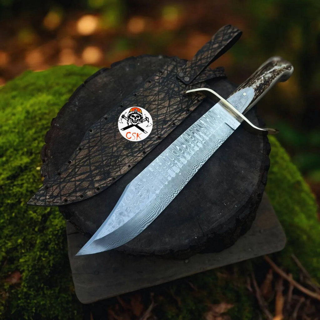 SS Damascus stag hunting knife by cskforged with custom leather sheath, featuring a detailed Damascus steel blade and stag handle.