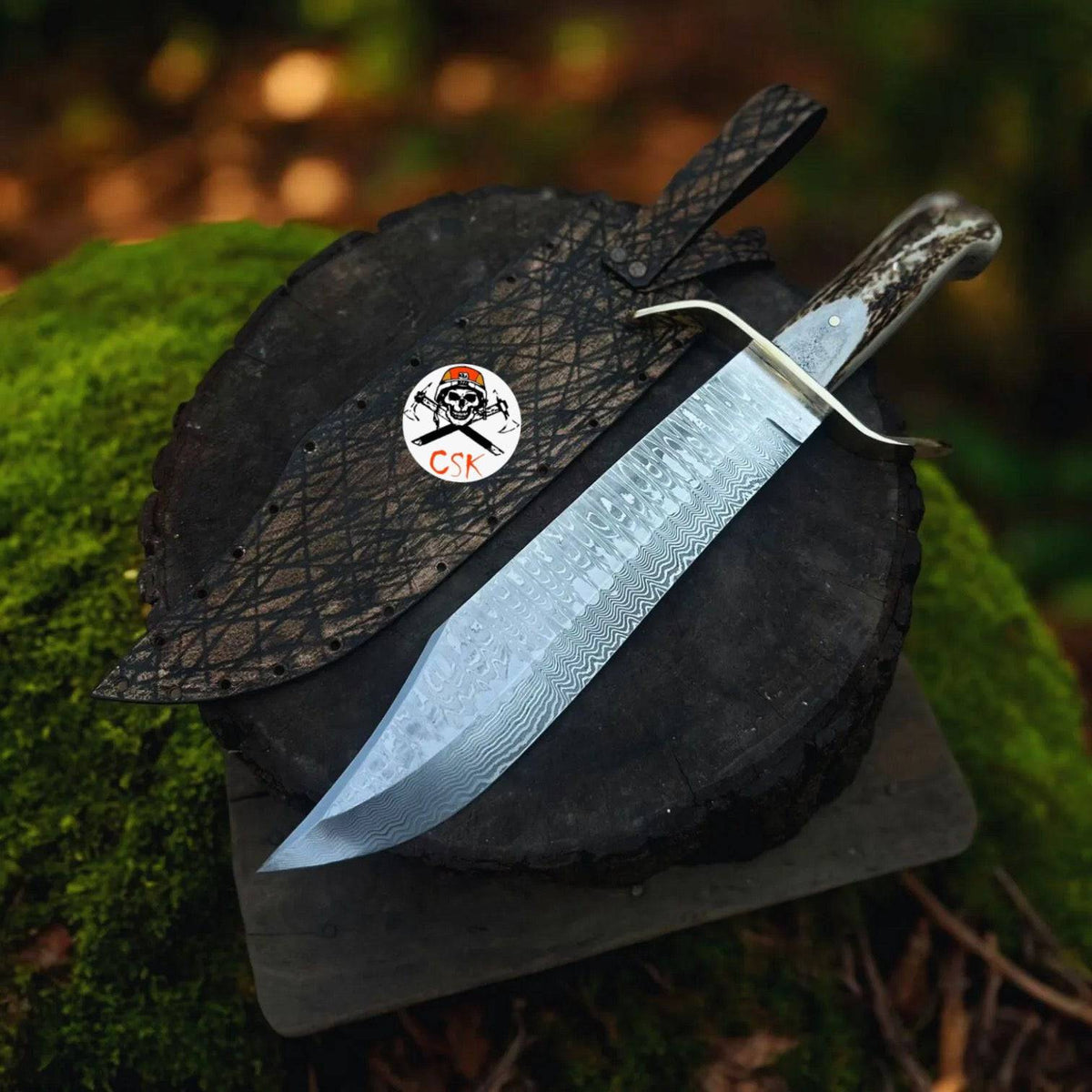 SS Damascus stag hunting knife by cskforged with custom leather sheath, featuring a detailed Damascus steel blade and stag handle.