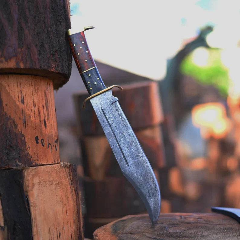 Handmade Damascus steel Rambo knife by cskforged with brass wood handle and leather sheath, showcasing detailed blade and handle design.