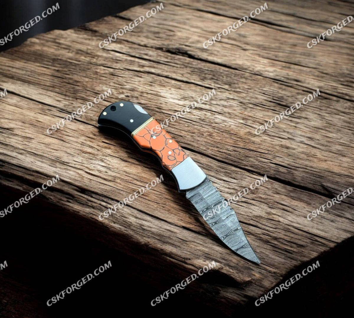 Damascus steel folding pocket knife with stone handle and leather sheath, handmade by CSK Forged.