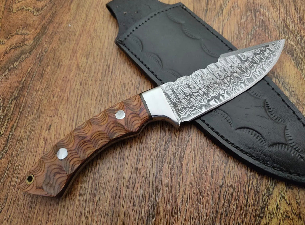 Custom handmade Damascus steel Bushcraft camping hunting knife from Knives Gear Garage with a leather handle and rugged blade.
