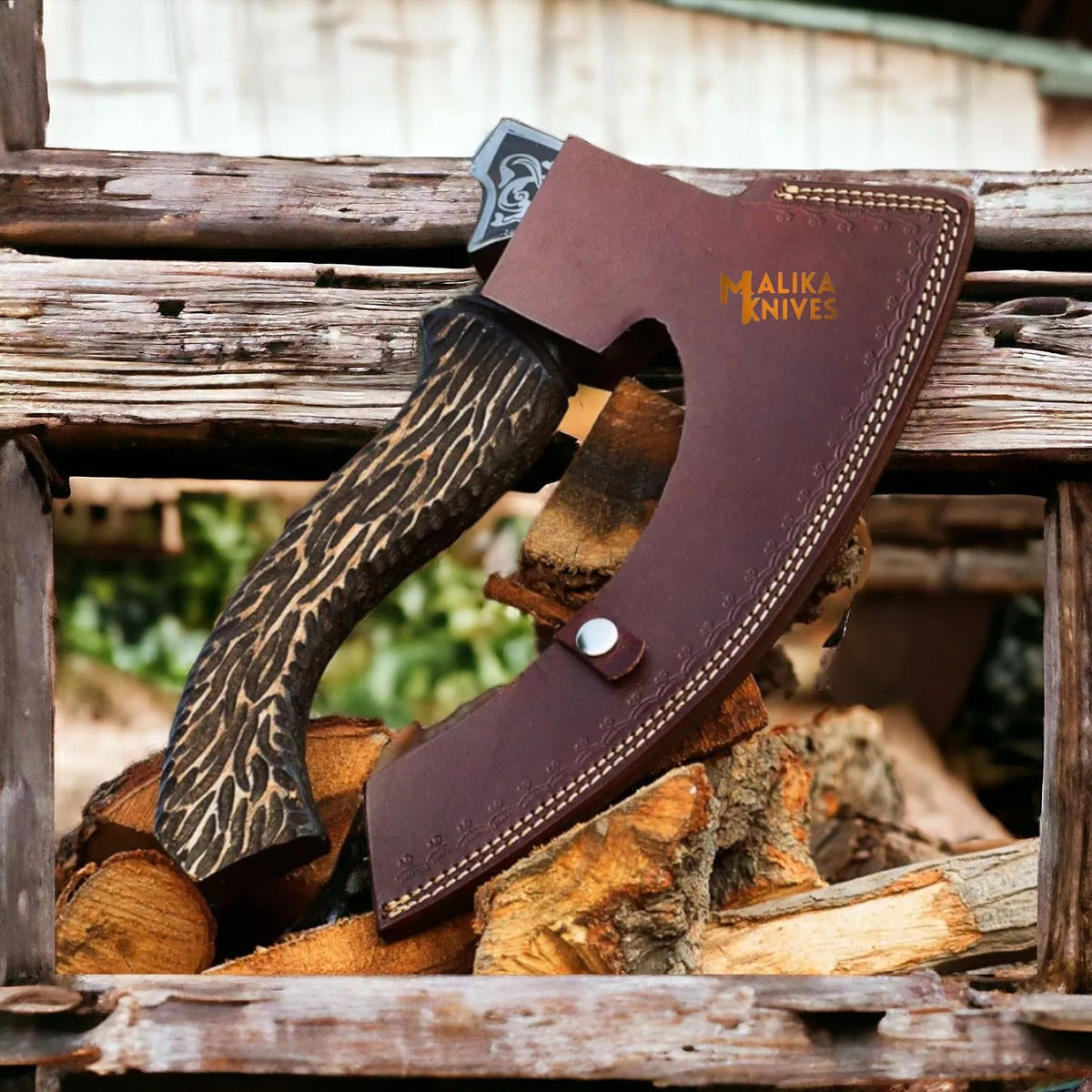Hand-forged Viking pizza cutter axe with leather sheath by MALIKA KNIVES, featuring detailed blade and rustic leather cover.