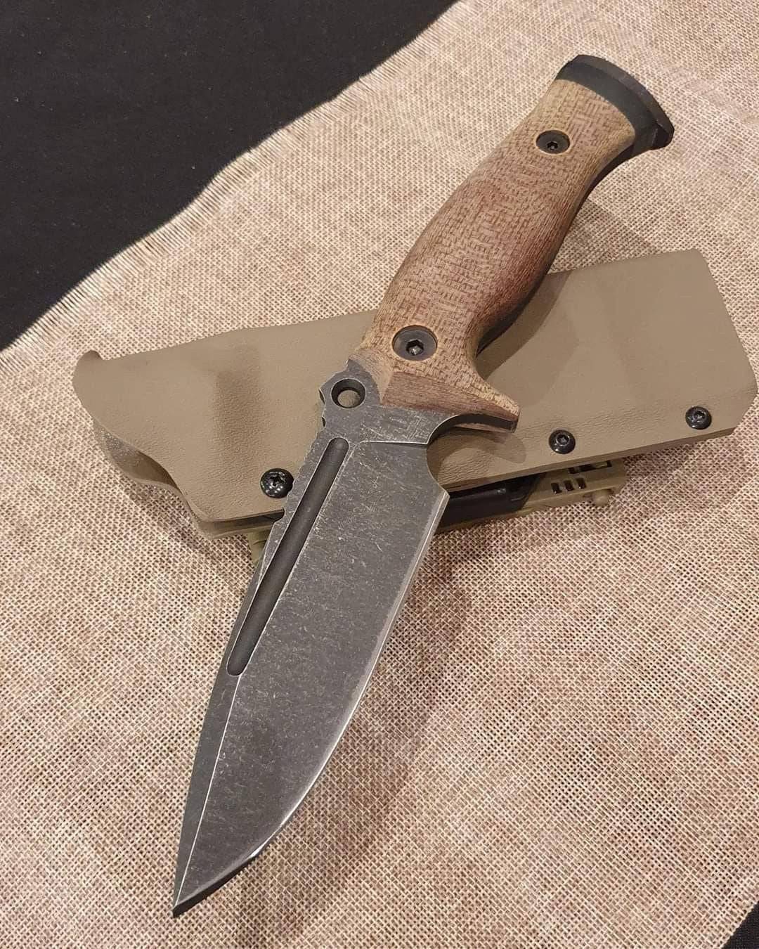Handmade bushcraft camping knife from Knives Gear Garage with a wooden handle and stainless steel blade, suitable for outdoor survival.