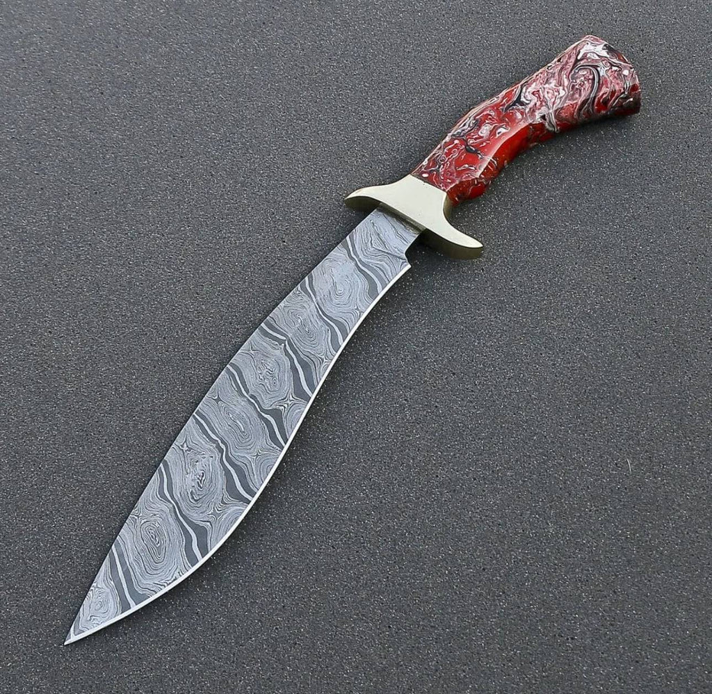 Custom handmade Damascus steel Bowie knife with resin handle and brass guard, shown with premium leather sheath.