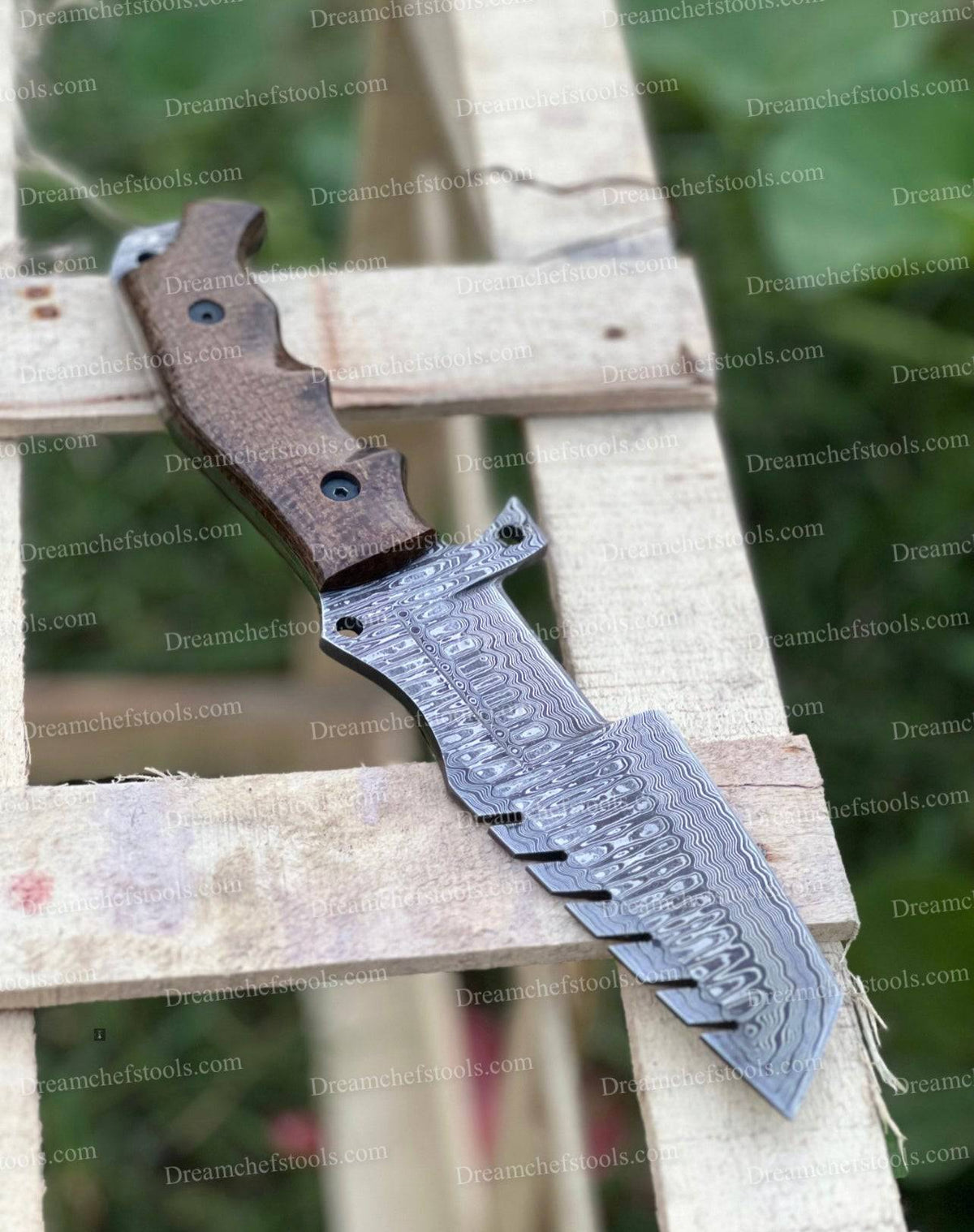Custom handmade Damascus steel tracker knife with intricate patterning and sturdy handle by Knives Gear Garage.