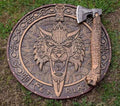 Knives Gear Garage axe and shield set with wooden handles and metal surfaces, displayed together on a neutral background.