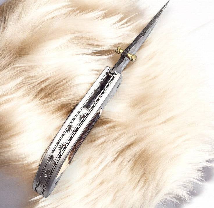Handmade Damascus pocket knife with stag horn handle and 3-inch blade, crafted by Damascus Knife Store.