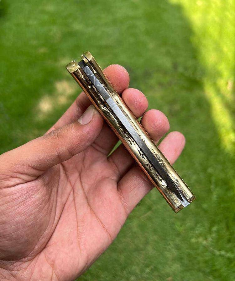 Damascus steel folding pocket knife with engraved brass handle, 8-inch custom knife by cskforged, featuring a sleek, detailed blade.
