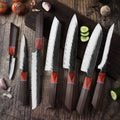 Handmade kitchen knife set by Knives Gear Garage featuring chef knives and barbecue tools on a wooden surface.