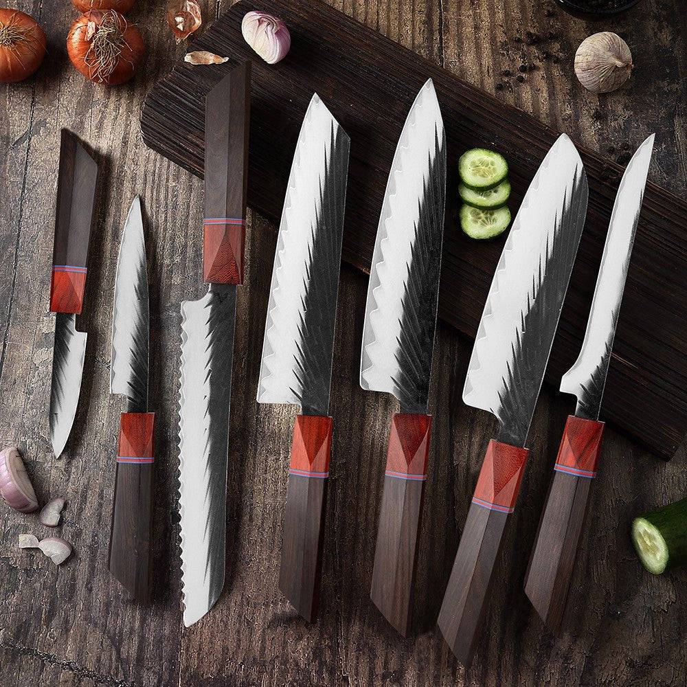 Handmade kitchen knife set by Knives Gear Garage featuring chef knives and barbecue tools on a wooden surface.