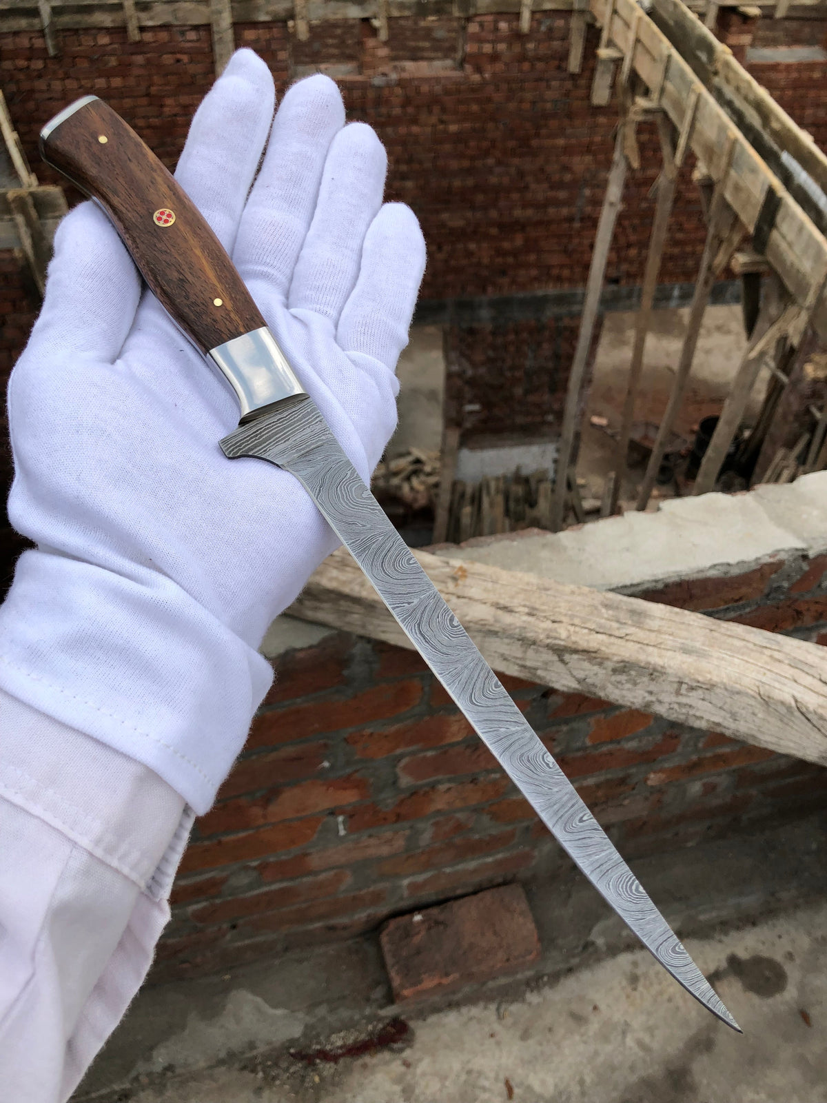 Fishing fillet knife by Knives Gear Garage with a sharp blade, ideal for cleaning fish in a professional or home fishing setting.