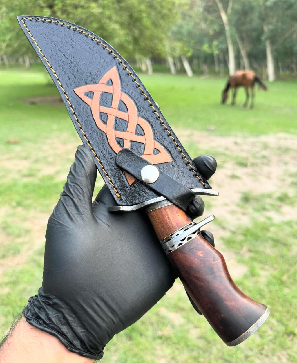 Custom handmade Damascus steel hunting Bowie knife with a wooden handle, crafted by Knives Gear Garage.