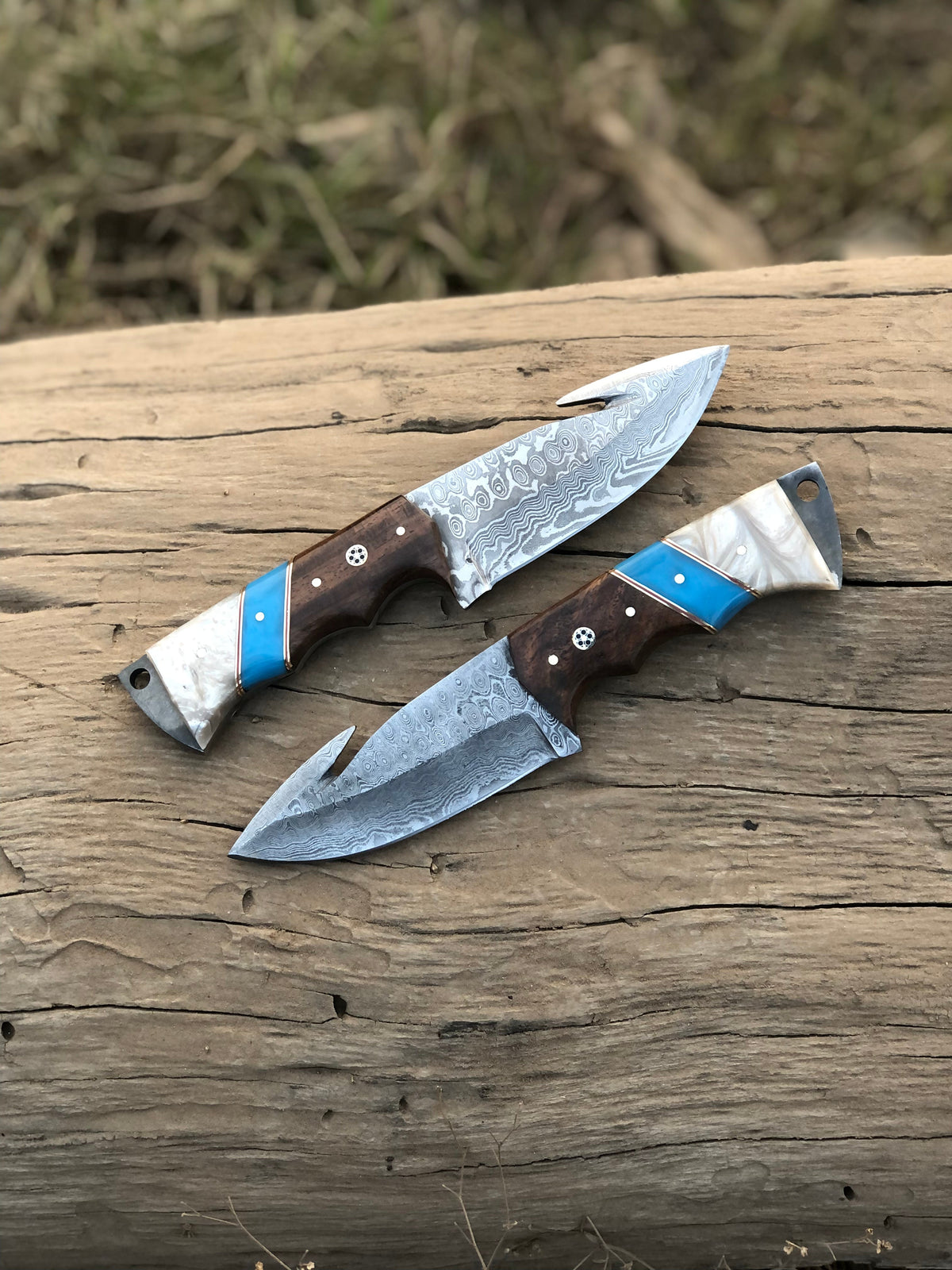 Custom handmade Damascus steel Guthook hunting knife with intricate blade pattern and leather handle, crafted by Knives Gear Garage.