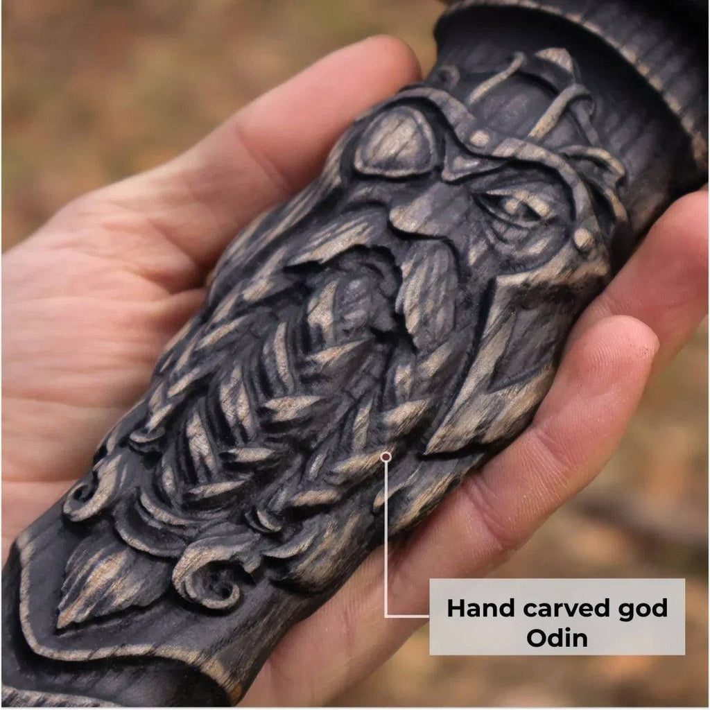 Close-up of a Viking Hammer hunting knife by cskforged, featuring a sharp blade and sturdy handle on a wooden background.