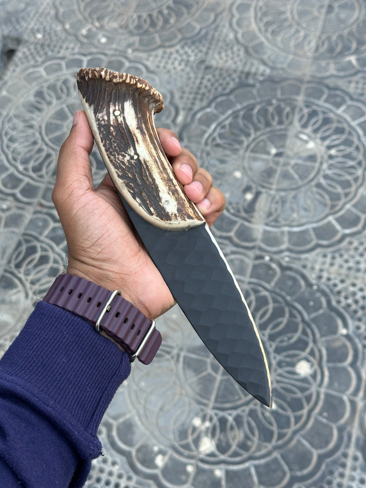 Hand forged steel hunting knife with a leather handle and sharp blade, crafted by Knives Gear Garage.
