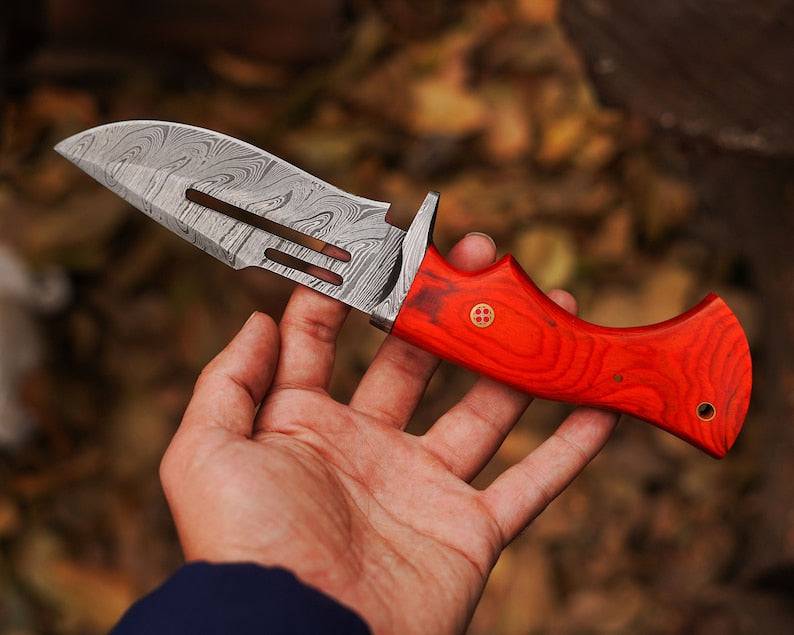 Damascus steel hunting knife by cskforged with a sharp blade and textured handle, designed for outdoor hunting and survival.