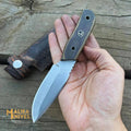 Close-up of a handcrafted MALIKA KNIVES EDC knife with a sleek blade and textured handle, designed for everyday use and durability.
