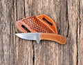 Custom cowboy knife with rasp steel blade and Micarta handle, featuring intricate craftsmanship and durable construction.