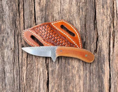 Custom cowboy knife with rasp steel blade and Micarta handle, featuring intricate craftsmanship and durable construction.
