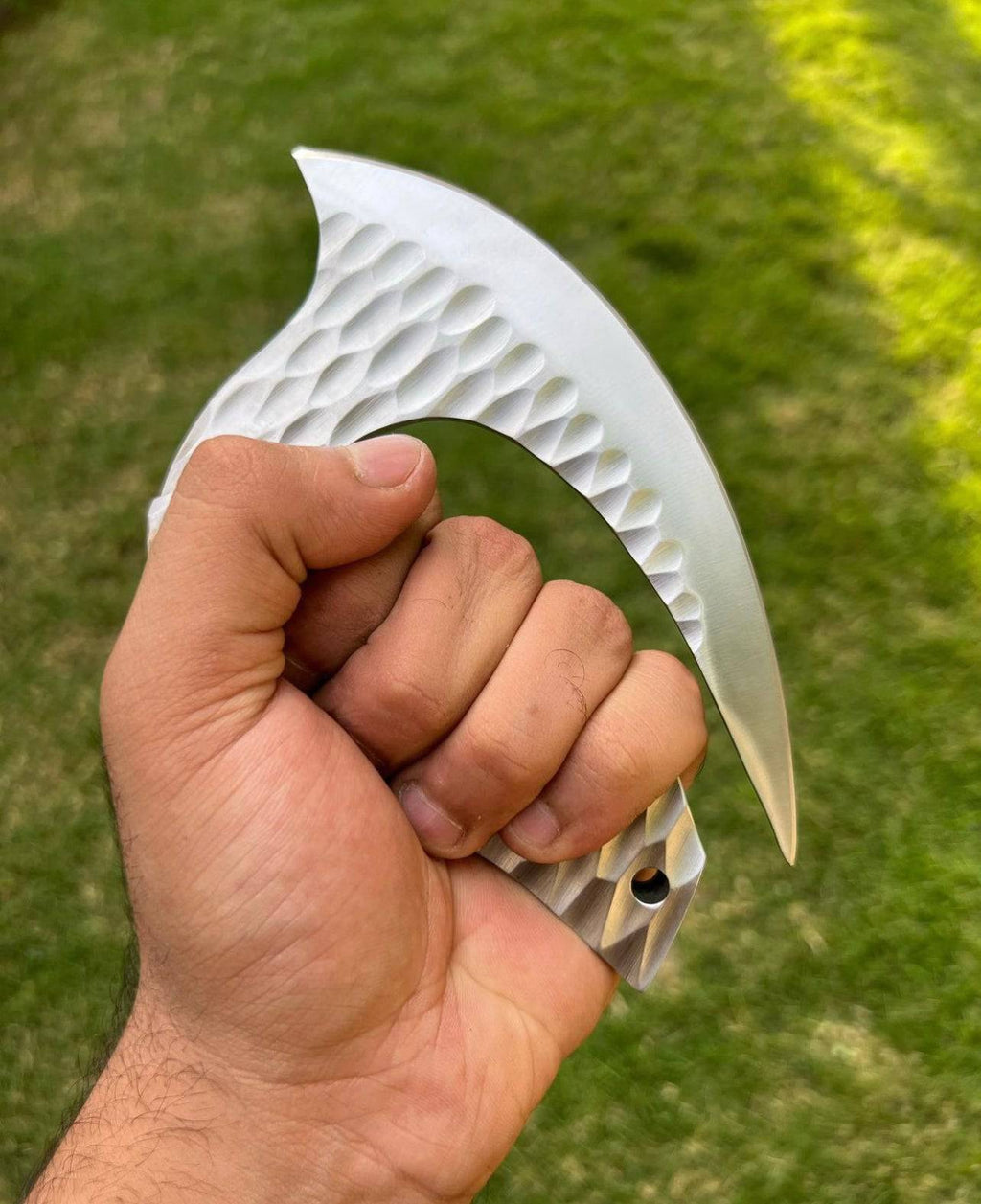 Handforged D2 steel Ulu chef knife by cskforged, showcasing a curved blade and wooden handle on a cutting board.