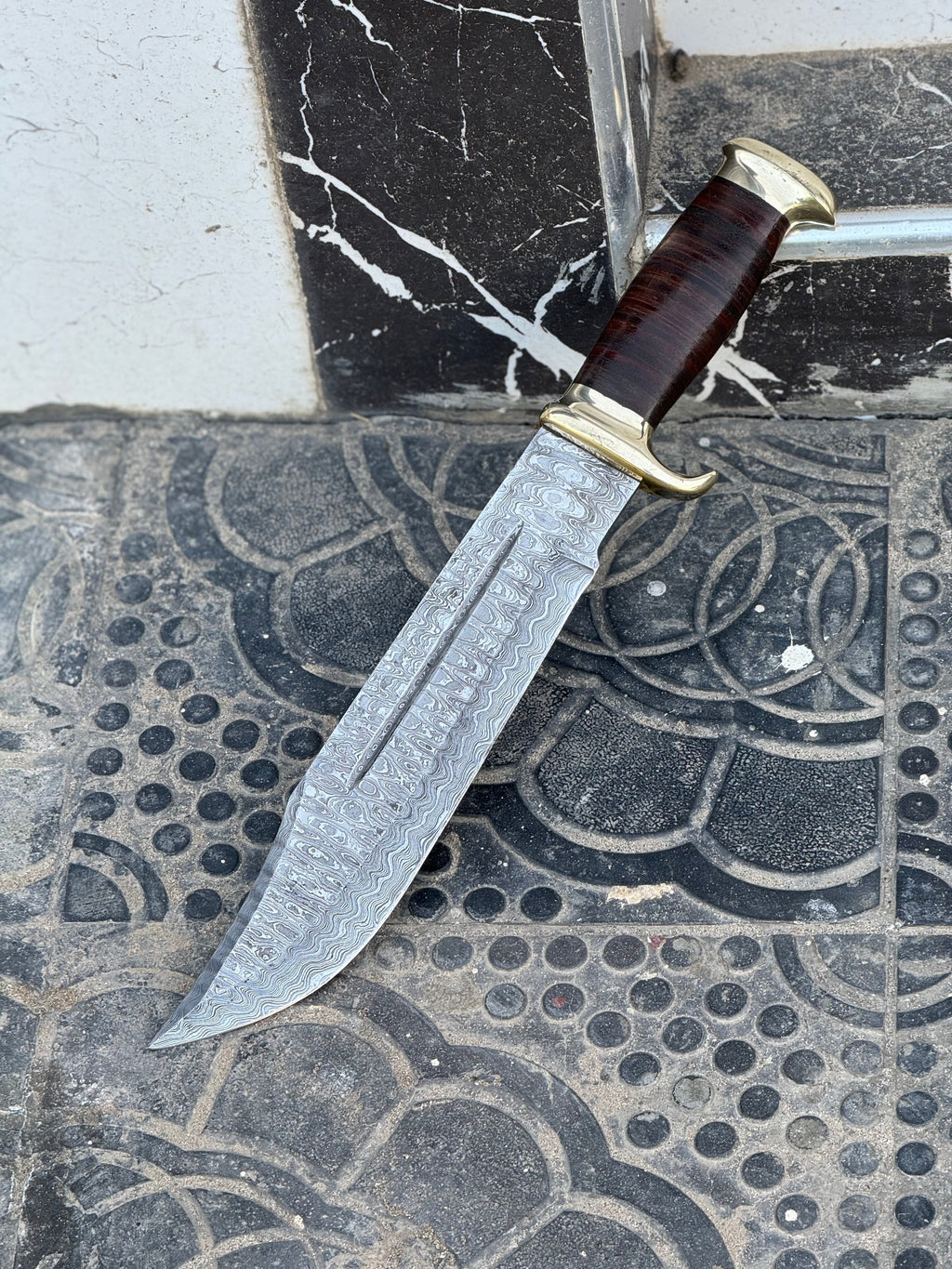 Custom handmade Damascus steel Crocodile Dundee Bowie knife with brass guard and leather handle, 16-inch blade from Knives Gear Garage.