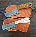 Custom handmade Damascus steel bull cutter knife with intricate patterning and a sturdy handle by Knives Gear Garage.