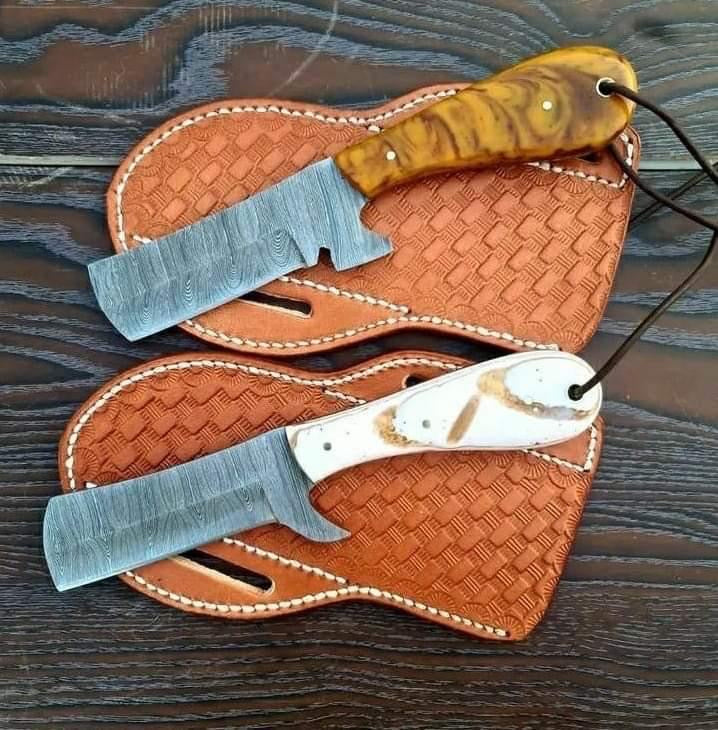 Custom handmade Damascus steel bull cutter knife with intricate patterning and a sturdy handle by Knives Gear Garage.