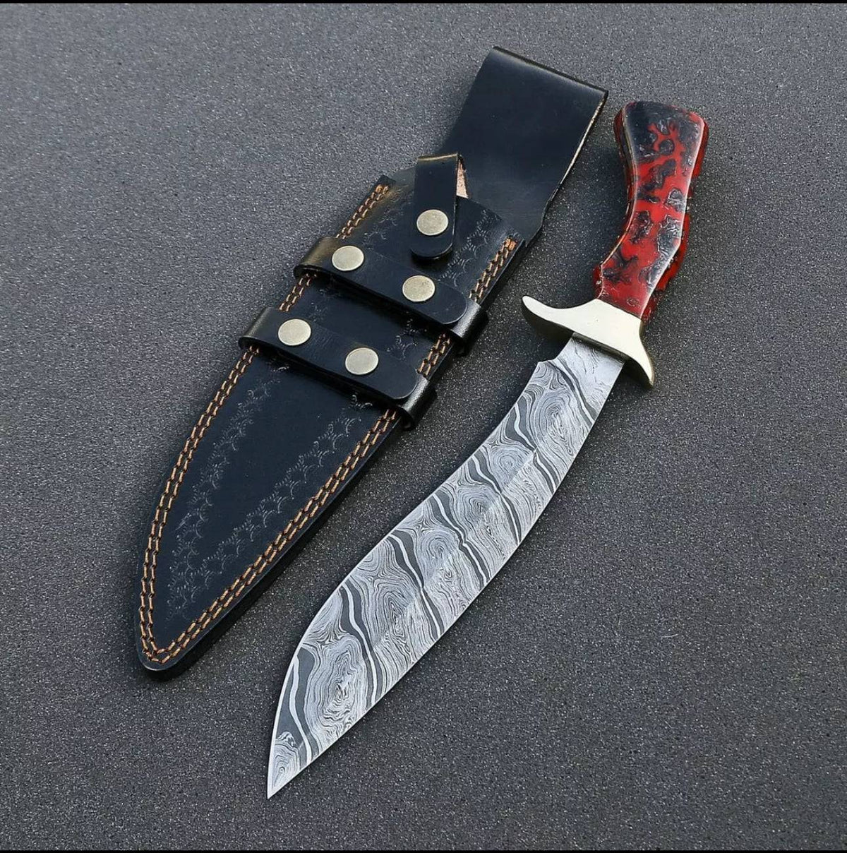 Custom handmade Damascus steel Bowie knife with brass guard and resin handle, featuring a premium leather sheath.