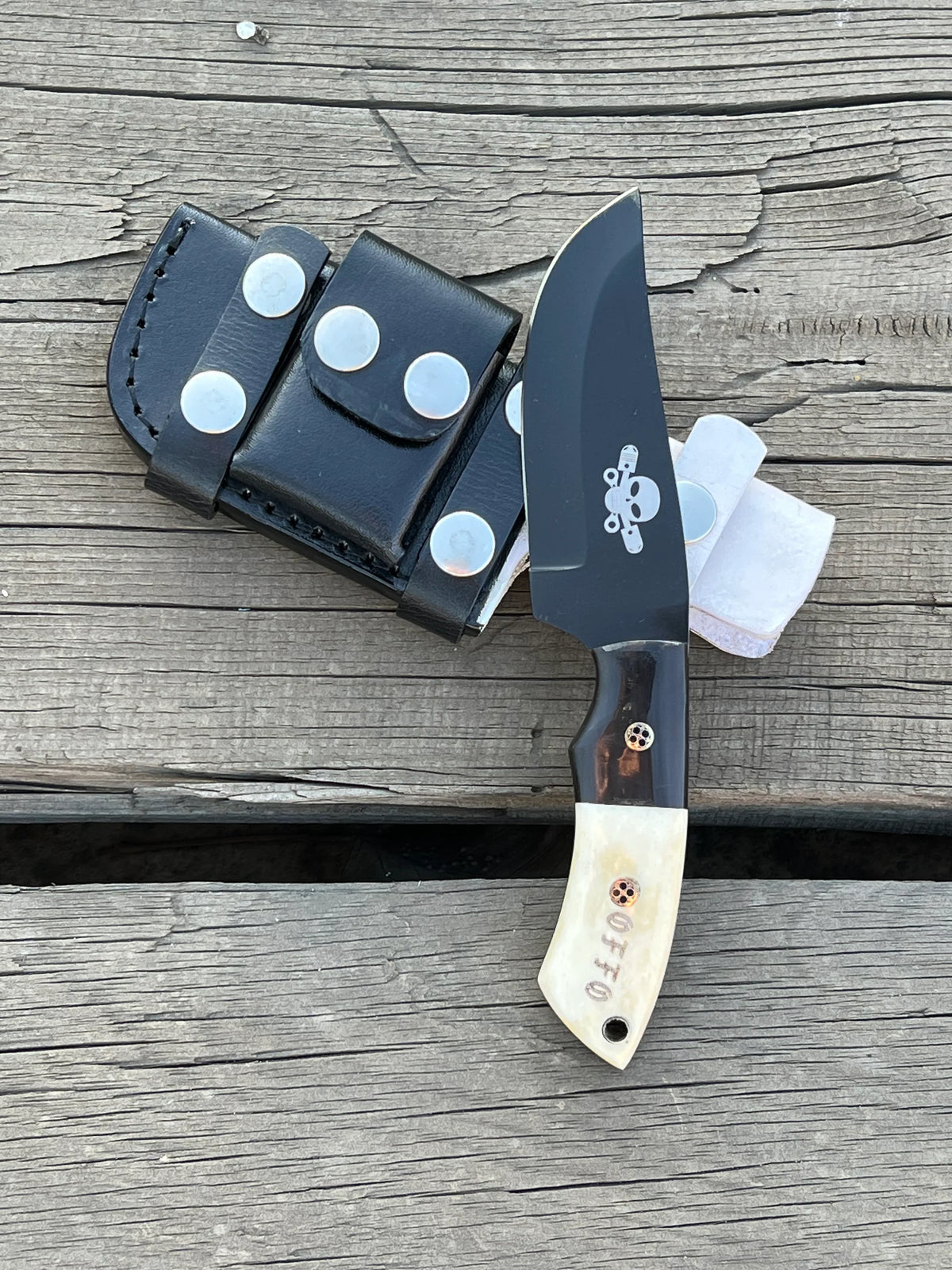 Handmade hunting knife with black-coated J2 steel full tang blade and custom handle, crafted by Knives Gear Garage.