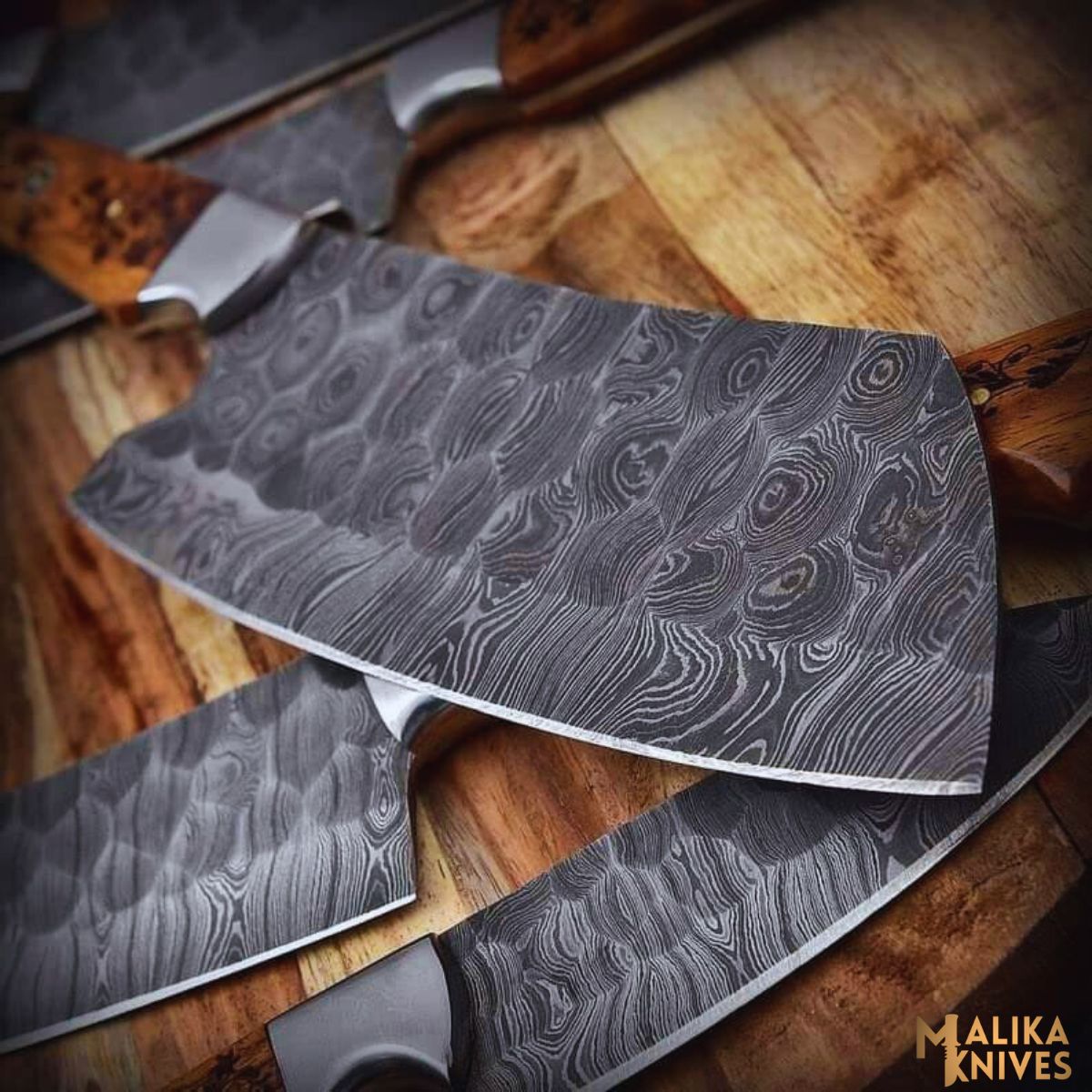 Set of four MALIKA KNIVES with sleek handles and sharp blades, perfect for professional cooking and home culinary prep.