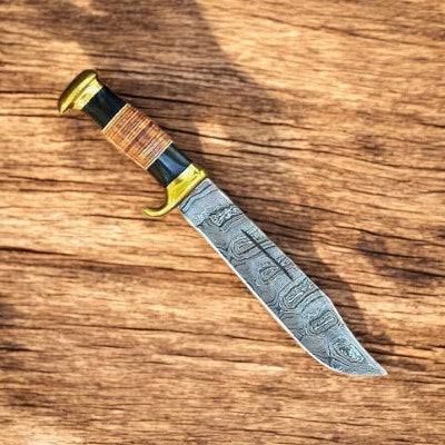 Handmade Damascus Bowie knife with 14-inch blade and buffalo horn handle, featuring intricate Damascus steel pattern.