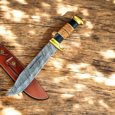 Handmade Damascus Bowie knife with a 14-inch blade and buffalo horn handle, featuring intricate Damascus steel patterns.