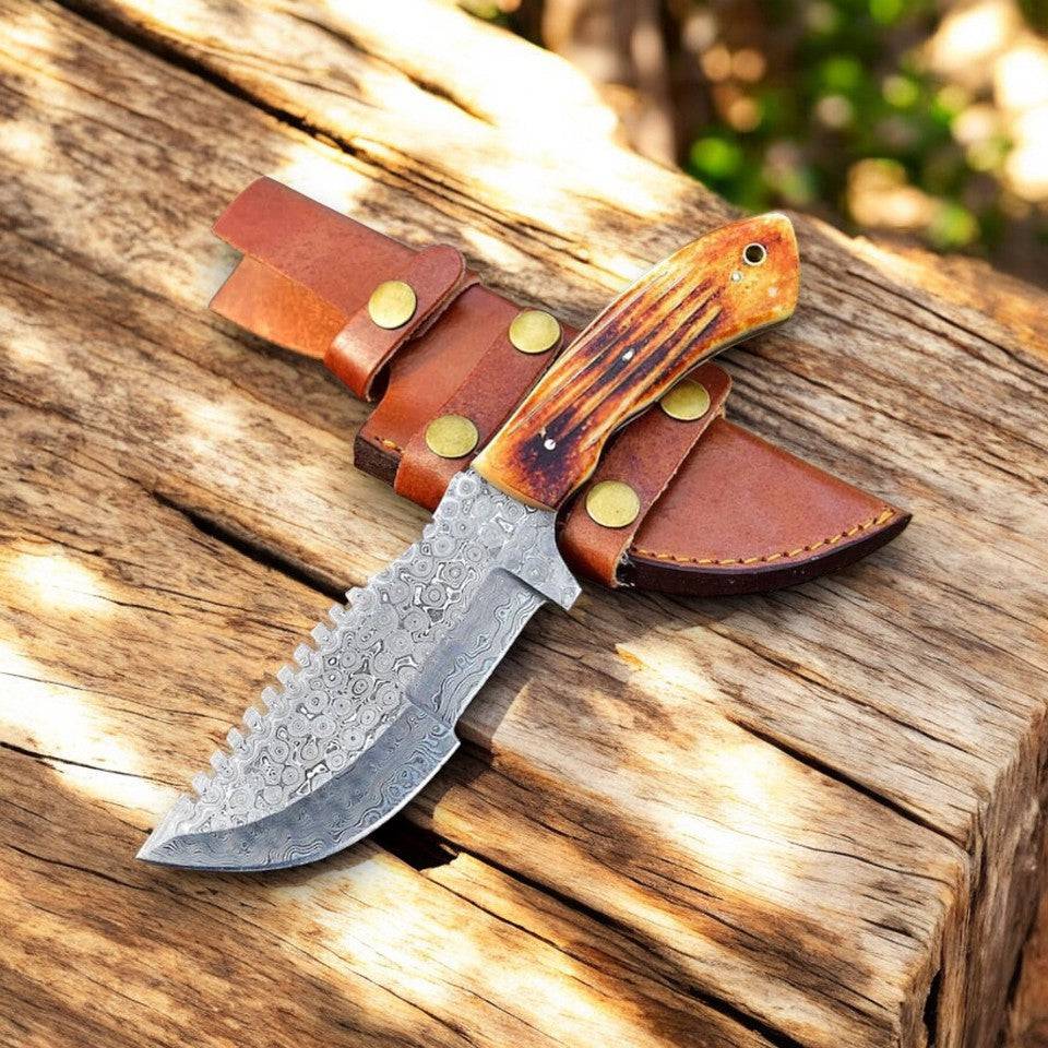 Handmade Damascus hunting knife with camel bone handle and intricate pattern, showcasing craftsmanship and durable blade.