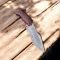 Handmade Damascus hunting knife with epoxy resin handle, featuring intricate blade pattern and ergonomic grip for outdoor use