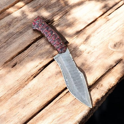 Handmade Damascus hunting knife with epoxy resin handle, featuring intricate blade pattern and ergonomic grip for outdoor use