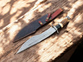 Handmade Damascus Bowie knife with antler horn handle and intricate blade design, crafted for durability and style.