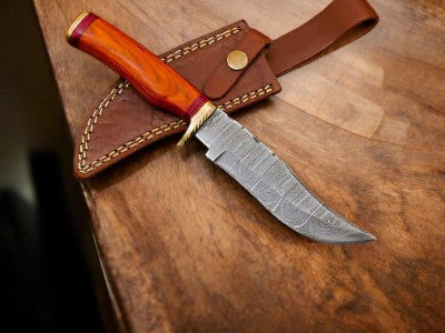 Handmade Damascus hunting knife with an 11-inch blade and wood handle, showcasing intricate Damascus steel pattern and craftsmanship.