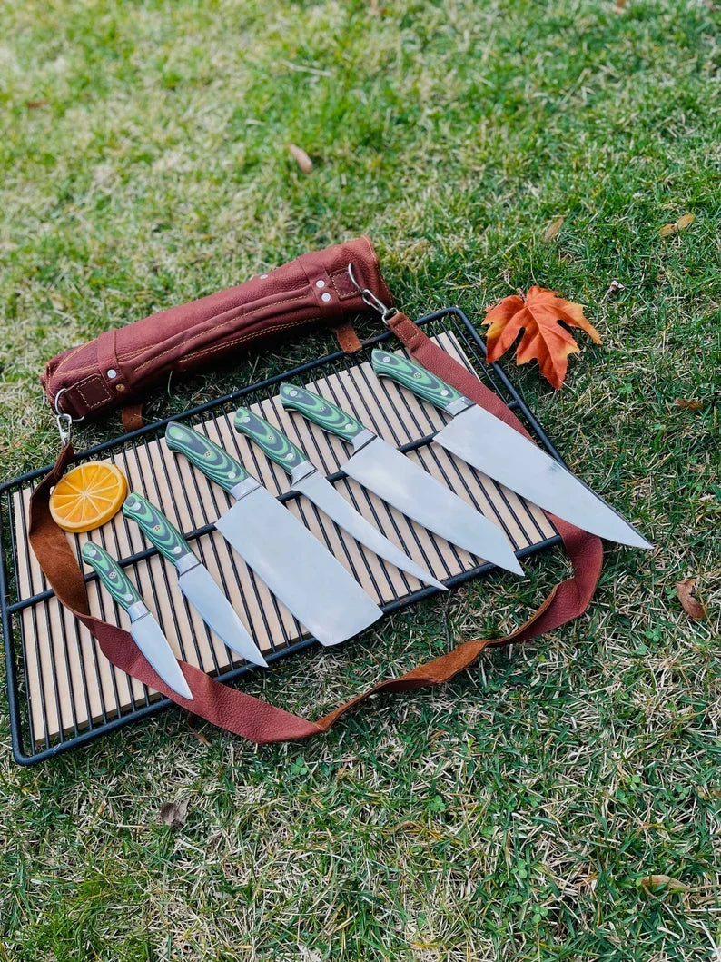 Custom handmade J2 Steel kitchen knife set with G10 handles, steel bolsters, and leather roll kit by Knives Gear Garage