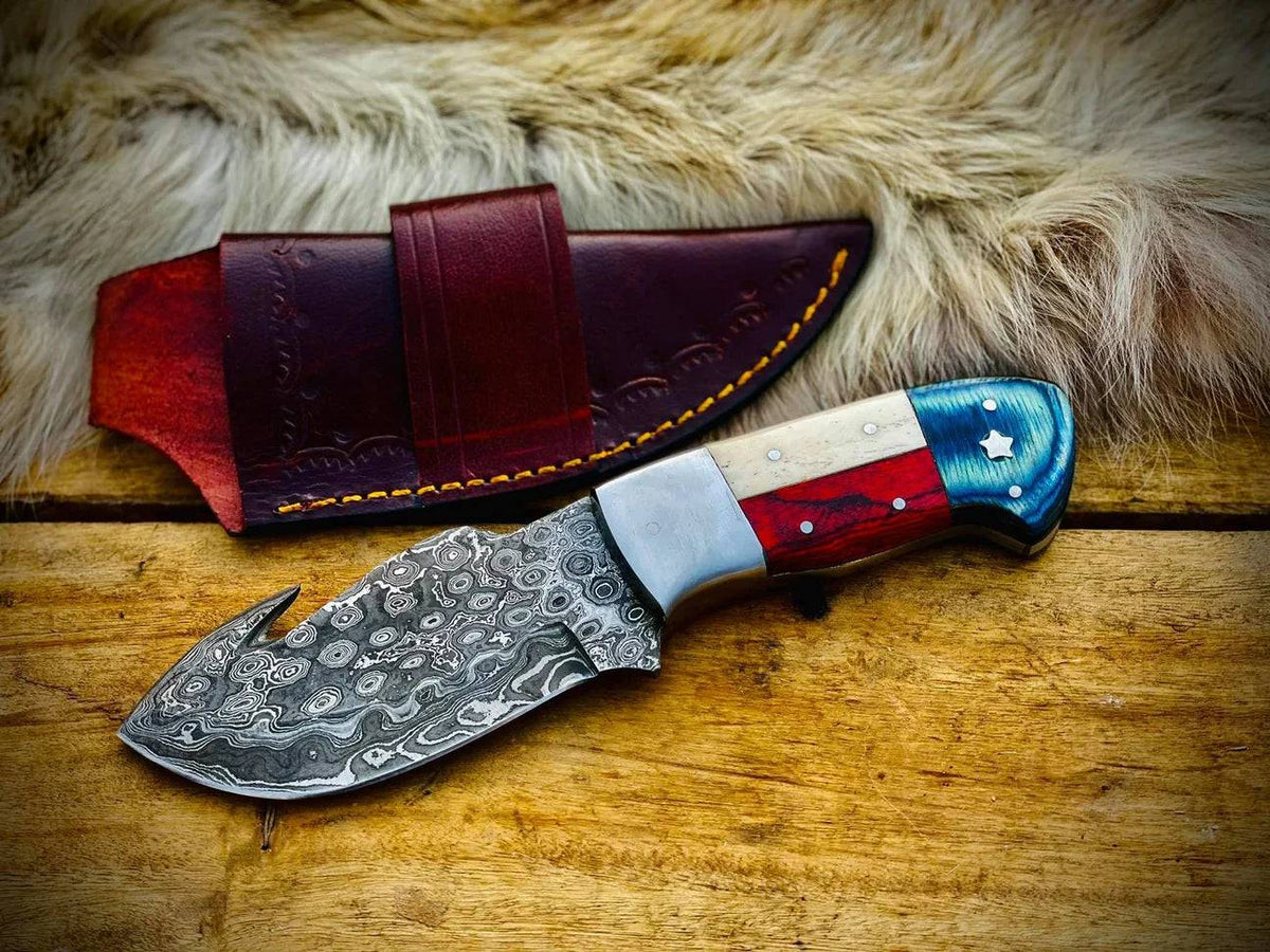 Handmade Texas flag handle gut hook skinning hunting knife by Knives Gear Garage with a durable blade and patriotic design.