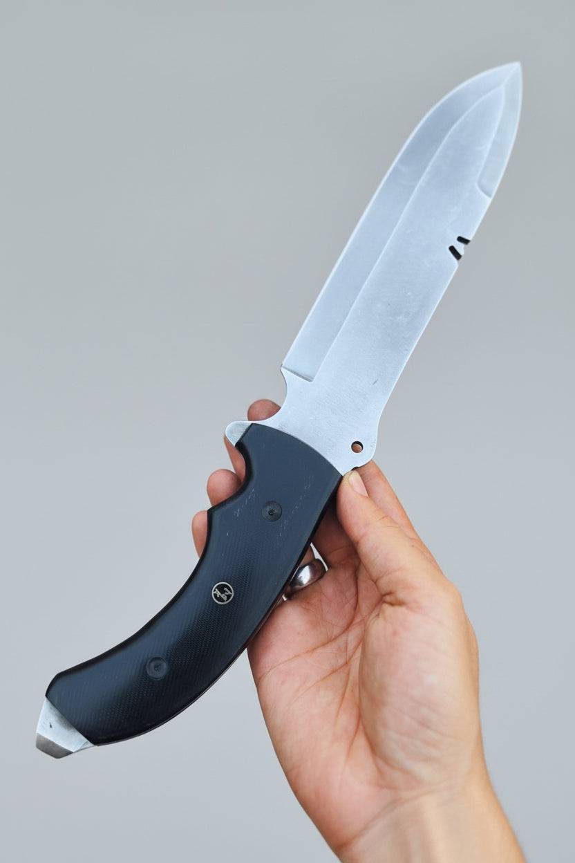 Close-up of MALIKA KNIVES Spear Point Bowie Knife with D2 steel blade and G10 Micarta handle, displayed on a plain background.
