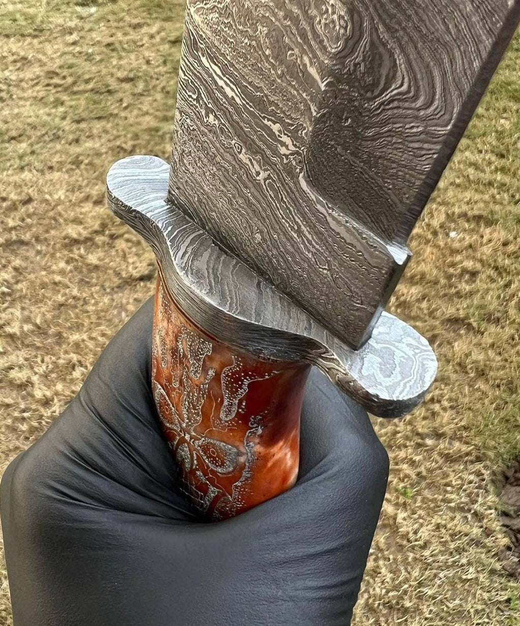 Handmade Damascus skull handle hunting knife by cskforged, featuring a detailed skull-shaped handle and sharp hunting blade.