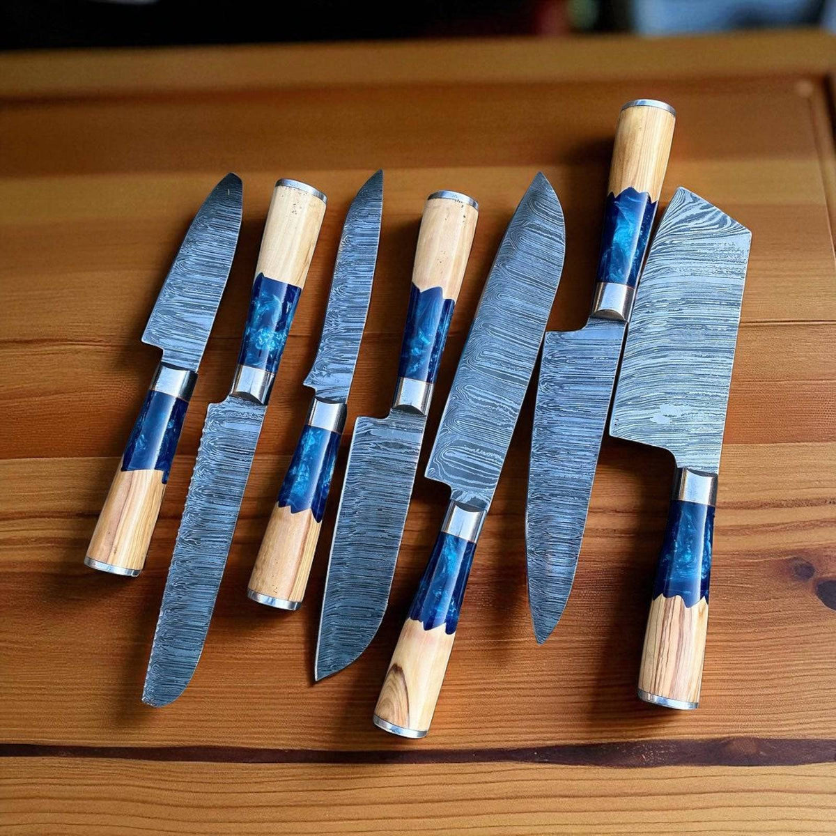 Handmade Damascus steel chef knife with resin and olivewood handle, steel bolster, and leather sheath from Knives Gear Garage kitchen knife set.