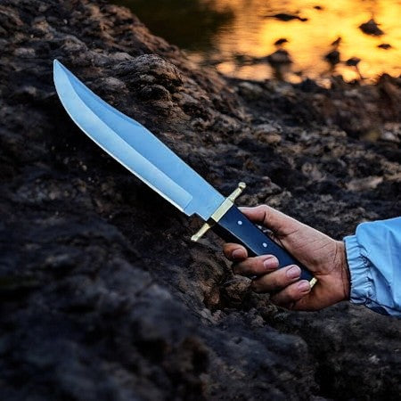 Handmade Bowie knife with D2 steel blade and buffalo horn handle, featuring detailed craftsmanship and a sturdy design.