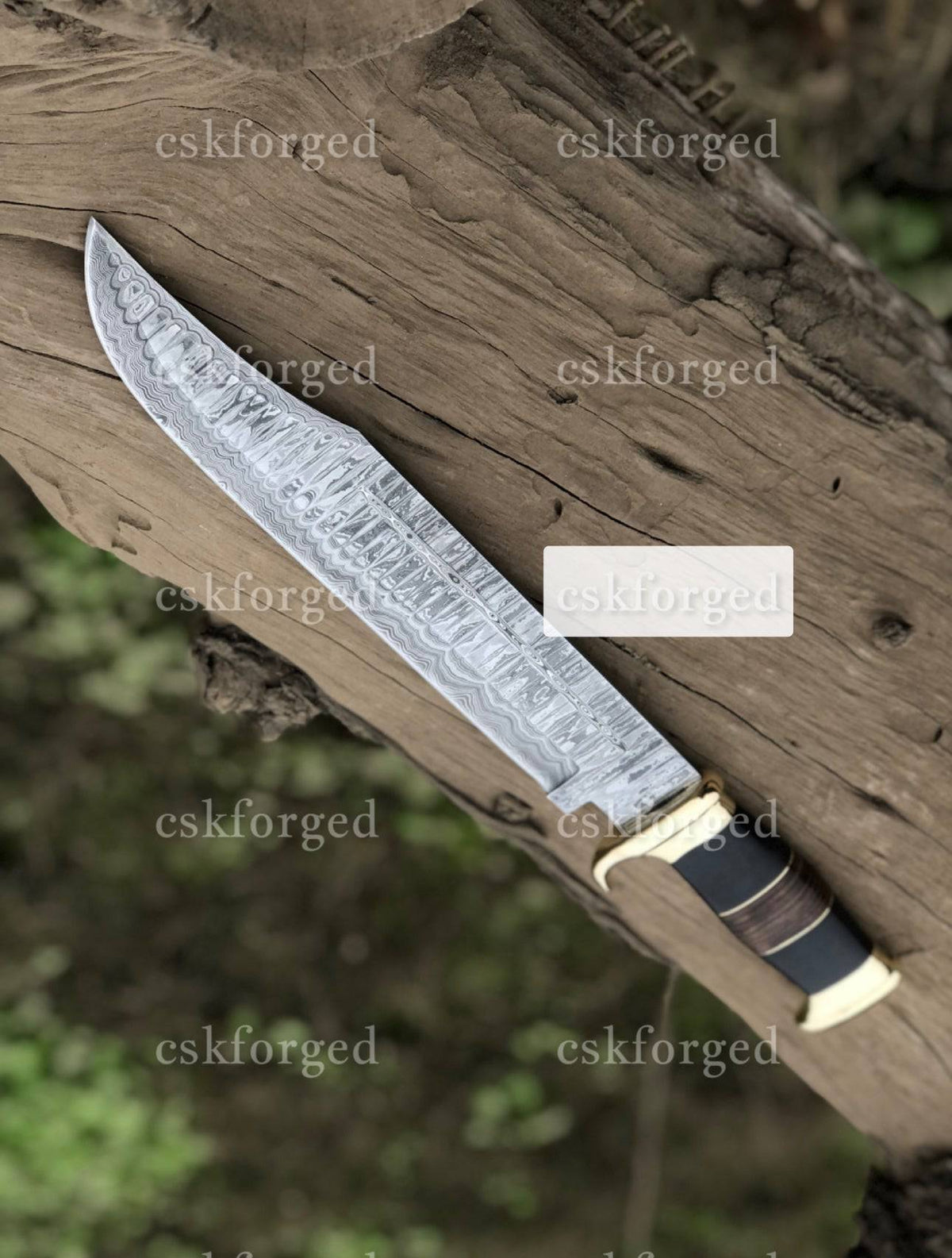 Handmade Damascus Steel Crocodile Dundee knife by cskforged with a textured handle and polished blade, designed for outdoor use.